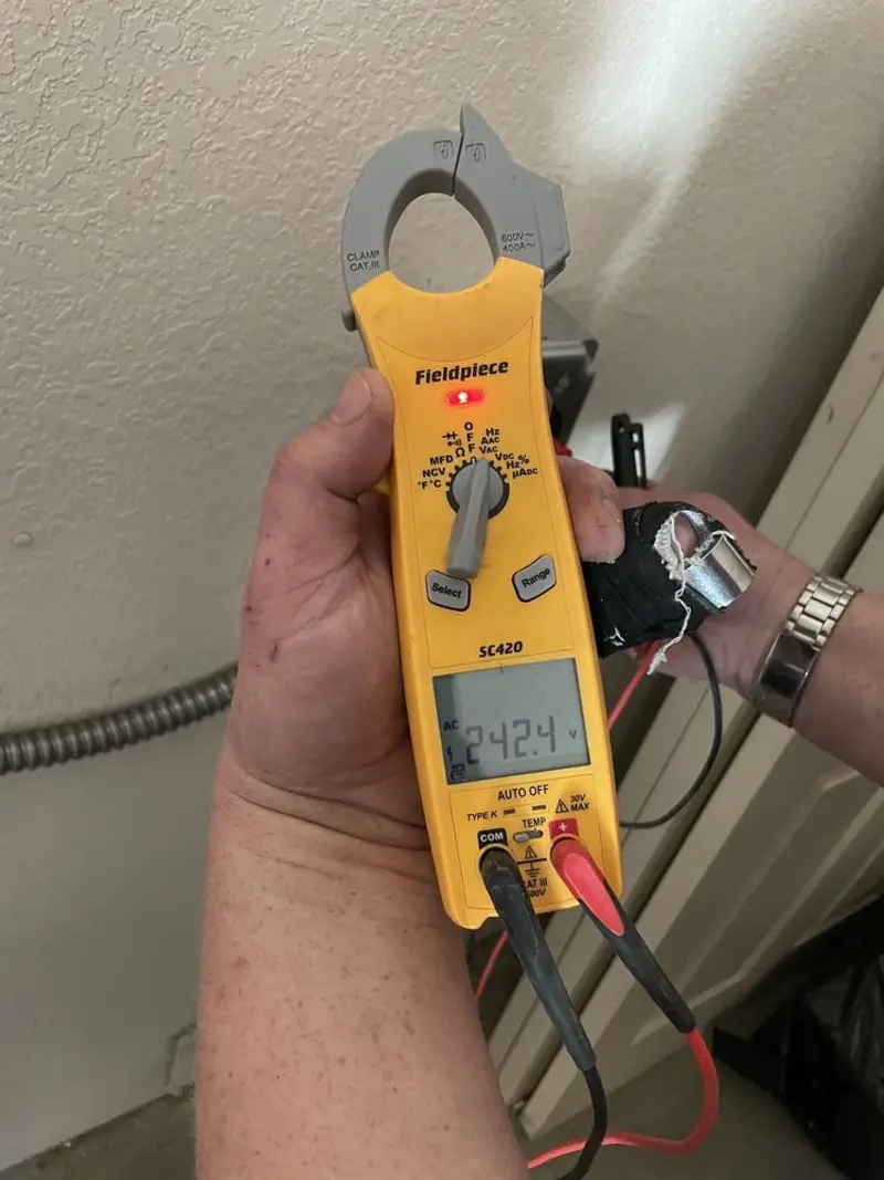 Voltage testing with clamp meter during Whole House Surge Protector in Rome